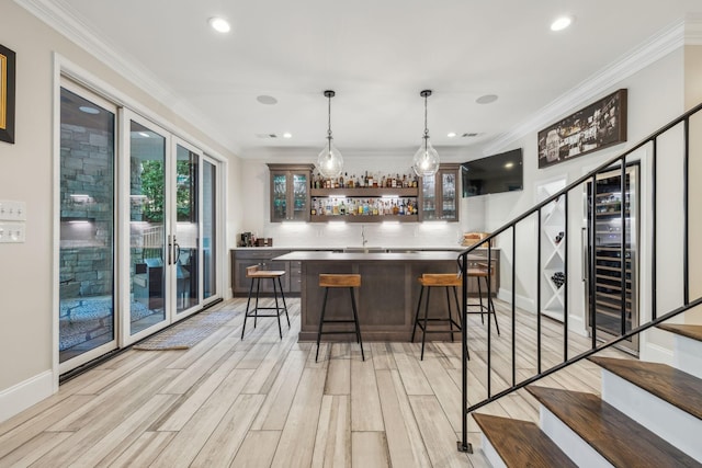 424 Wild Elm St, Franklin, TN 37064 - indoor bar with wine cooler, ornamental molding, light wood-style floors, stairs, and recessed lighting