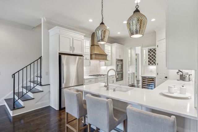 424 Wild Elm St, Franklin, TN 37064 - kitchen featuring appliances with stainless steel finishes, a sink, beverage cooler, tasteful backsplash, and crown molding