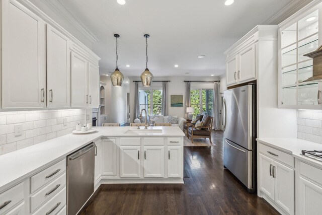 424 Wild Elm St, Franklin, TN 37064 - kitchen featuring appliances with stainless steel finishes, a sink, open floor plan, a peninsula, and white cabinets