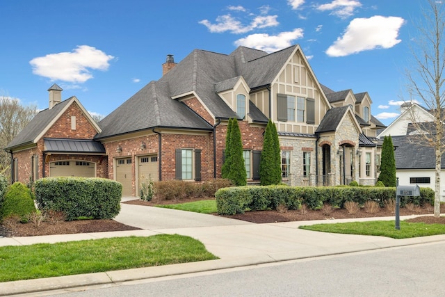 8704 Wolfsbane Ln, College Grove, TN 37046 - view of front facade with roof with shingles, a garage, brick siding, a standing seam roof, and concrete driveway