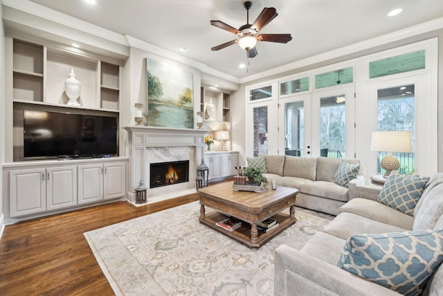 8704 Wolfsbane Ln, College Grove, TN 37046 - living area featuring crown molding, a ceiling fan, wood finished floors, a high end fireplace, and built in shelves