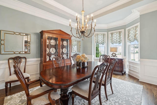 8704 Wolfsbane Ln, College Grove, TN 37046 - dining area featuring a chandelier, crown molding, a wainscoted wall, wood finished floors, and a decorative wall