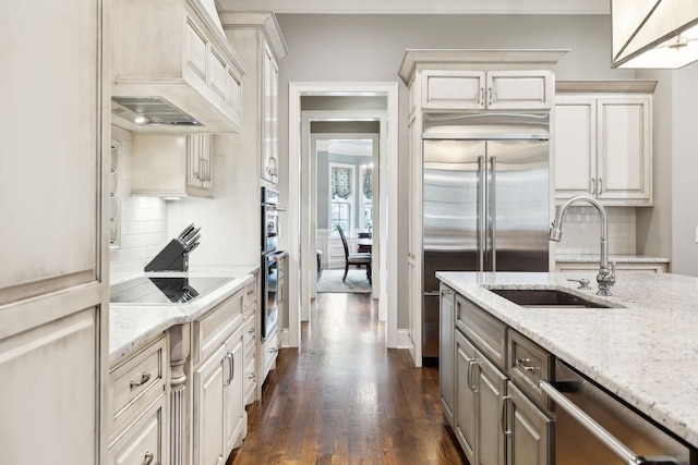 8704 Wolfsbane Ln, College Grove, TN 37046 - kitchen with appliances with stainless steel finishes, tasteful backsplash, dark wood-style floors, and light stone counters