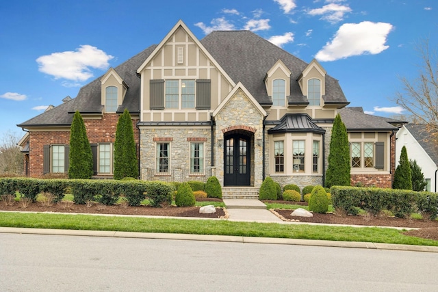 8704 Wolfsbane Ln, College Grove, TN 37046 - view of front facade featuring roof with shingles, stone siding, and a standing seam roof