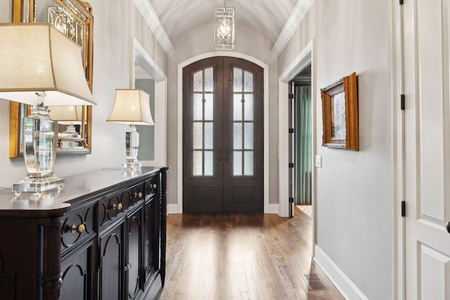 8704 Wolfsbane Ln, College Grove, TN 37046 - entrance foyer with french doors, wood finished floors, a chandelier, arched walkways, and vaulted ceiling
