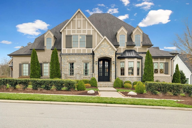 8704 Wolfsbane Ln, College Grove, TN 37046 - view of front facade featuring stone siding, roof with shingles, and a standing seam roof
