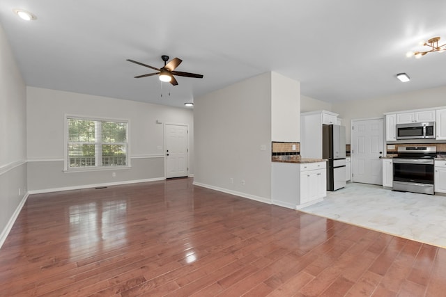 2905 Burtonwood Dr, Spring Hill, TN 37174 - unfurnished living room featuring a ceiling fan, light wood-style floors, and baseboards
