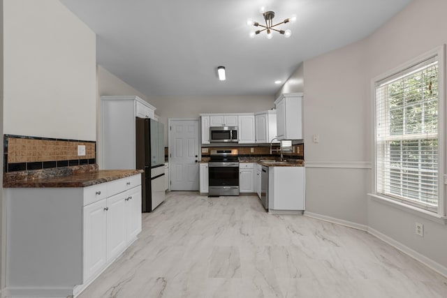 2905 Burtonwood Dr, Spring Hill, TN 37174 - kitchen with stainless steel appliances, light marble finish floors, a chandelier, white cabinetry, and a sink