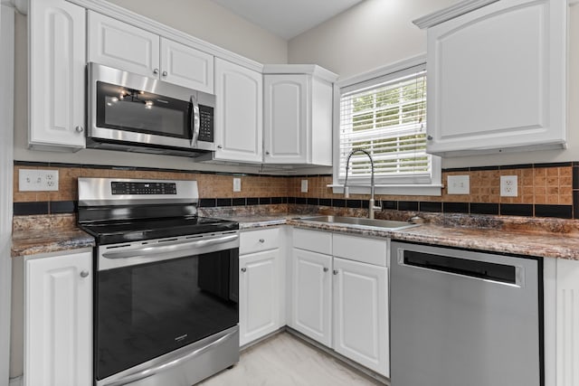 2905 Burtonwood Dr, Spring Hill, TN 37174 - kitchen featuring appliances with stainless steel finishes, a sink, white cabinets, and dark countertops