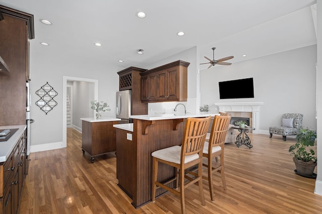 1417 Guill Rd, Mount Juliet, TN 37122 - kitchen with appliances with stainless steel finishes, a ceiling fan, a center island, open floor plan, and wood finished floors
