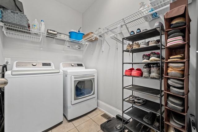 1417 Guill Rd, Mount Juliet, TN 37122 - laundry area with washing machine and dryer, light tile patterned flooring, and baseboards