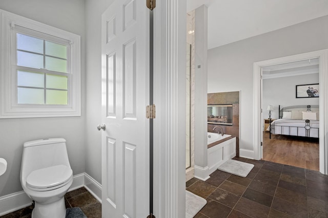 1417 Guill Rd, Mount Juliet, TN 37122 - full bath with a garden tub, connected bathroom, baseboards, stone finish flooring, and a stall shower