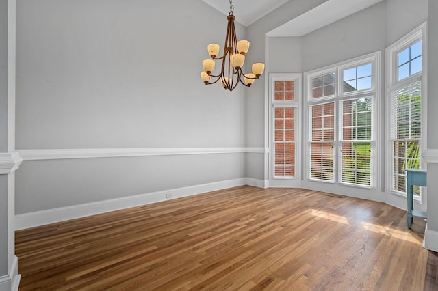 1417 Guill Rd, Mount Juliet, TN 37122 - unfurnished dining area with a chandelier, wood finished floors, ornamental molding, and baseboards