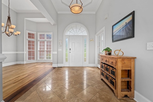 1417 Guill Rd, Mount Juliet, TN 37122 - foyer entrance with a chandelier, baseboards, crown molding, inlaid floor details, and a towering ceiling