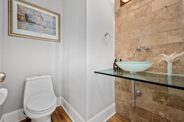 1417 Guill Rd, Mount Juliet, TN 37122 - half bathroom with a sink, baseboards, wood finished floors, and toilet