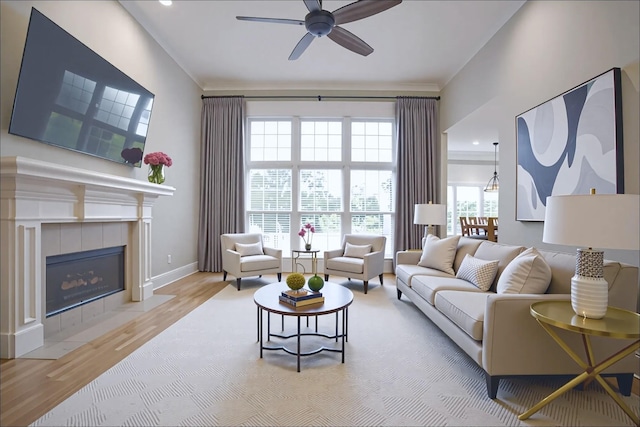 1417 Guill Rd, Mount Juliet, TN 37122 - living room featuring ceiling fan, wood finished floors, ornamental molding, recessed lighting, and a tiled fireplace