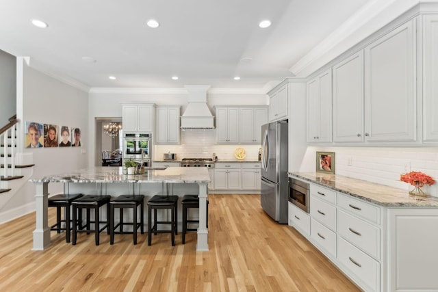 4043 Old Light Cir, Arrington, TN 37014 - kitchen featuring stainless steel appliances, premium range hood, ornamental molding, decorative backsplash, and a kitchen bar