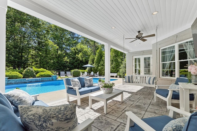 4043 Old Light Cir, Arrington, TN 37014 - view of patio / terrace with french doors, an outdoor living space, an outdoor pool, a ceiling fan, and view of scattered trees