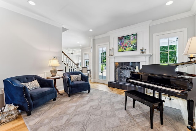 4043 Old Light Cir, Arrington, TN 37014 - sitting room featuring ornamental molding, plenty of natural light, stairway, wood finished floors, and a fireplace