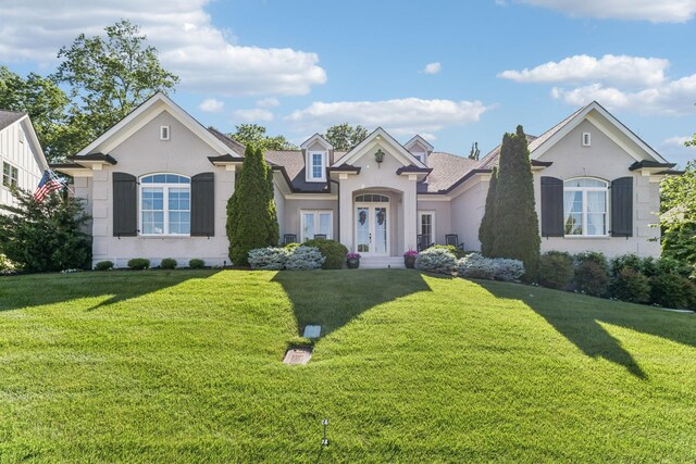 4043 Old Light Cir, Arrington, TN 37014 - french country style house featuring a front lawn, french doors, stucco siding, and roof with shingles