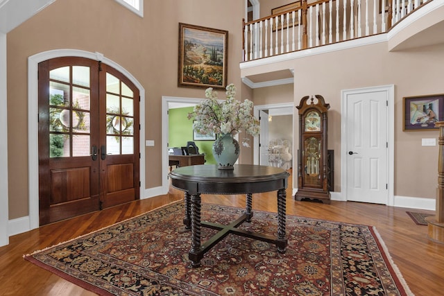 3285 Blazer Rd, Franklin, TN 37064 - entryway with french doors, a towering ceiling, arched walkways, wood finished floors, and baseboards