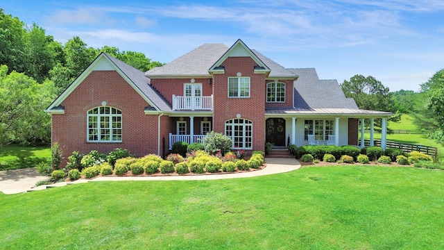 3285 Blazer Rd, Franklin, TN 37064 - colonial-style house with brick siding, a porch, a front yard, a shingled roof, and a standing seam roof