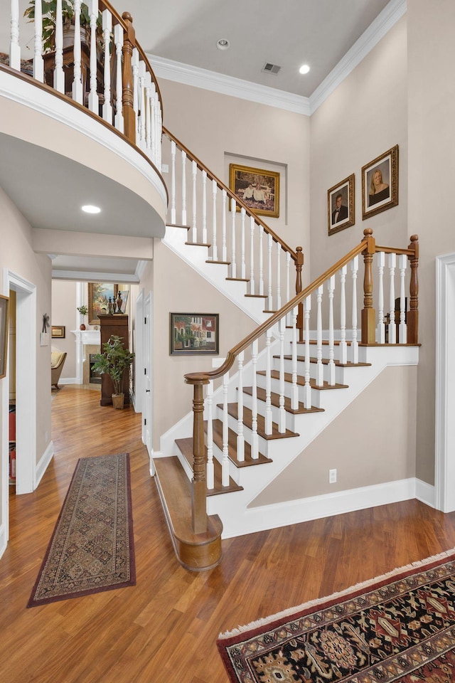 3285 Blazer Rd, Franklin, TN 37064 - stairway featuring wood finished floors, ornamental molding, baseboards, recessed lighting, and a fireplace