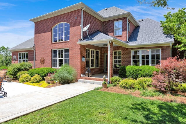 3285 Blazer Rd, Franklin, TN 37064 - back of house featuring brick siding, roof with shingles, and a yard