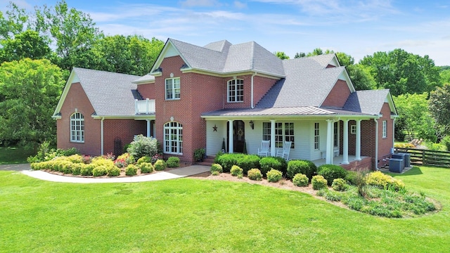 3285 Blazer Rd, Franklin, TN 37064 - view of front of house with brick siding, a standing seam roof, covered porch, and central AC
