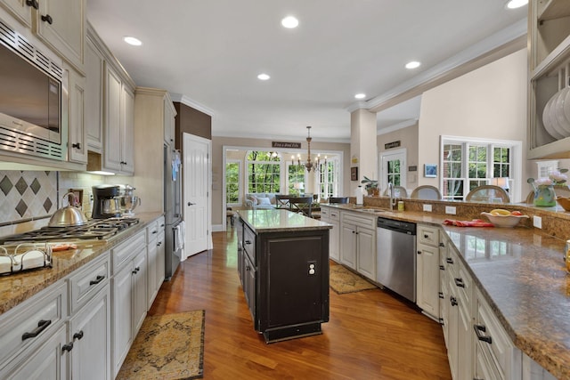 3285 Blazer Rd, Franklin, TN 37064 - kitchen featuring stainless steel appliances, ornamental molding, a chandelier, wood finished floors, and a sink
