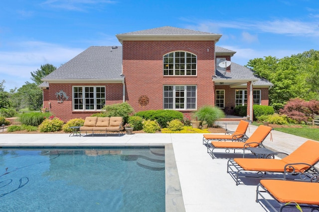 3285 Blazer Rd, Franklin, TN 37064 - back of property featuring a patio, an outdoor pool, brick siding, an outdoor hangout area, and a shingled roof