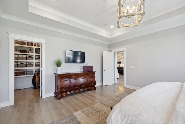 5304 Eagle Trail Ct, Franklin, TN 37064 - bedroom featuring a tray ceiling, a spacious closet, a chandelier, wood finished floors, and crown molding