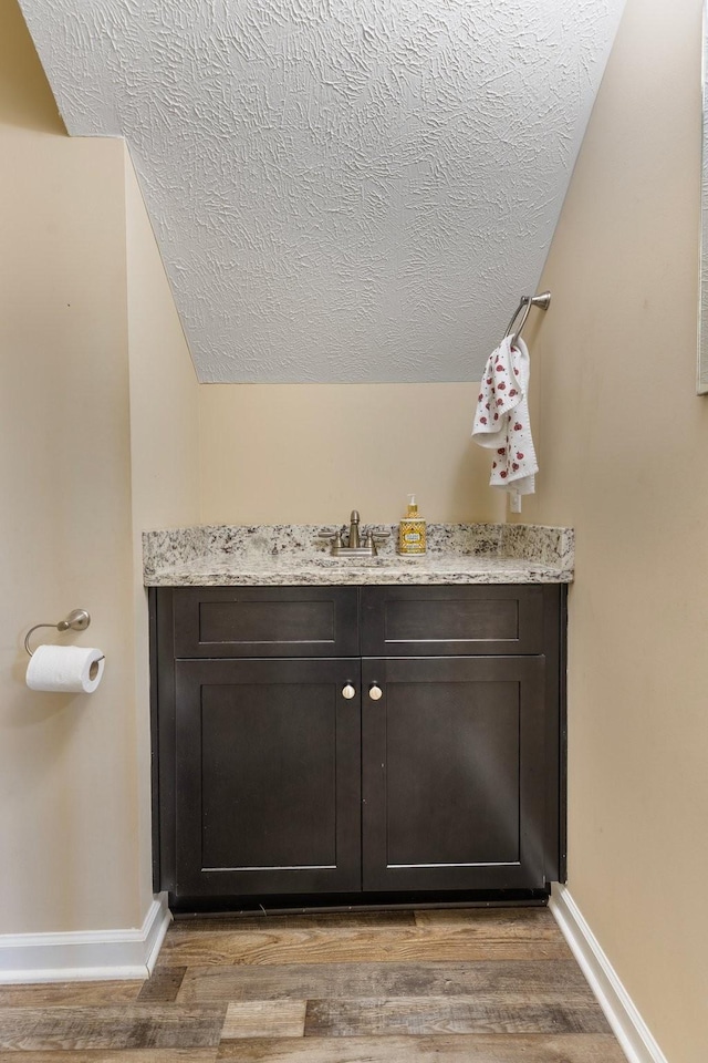 1710 Collins Hollow Rd, Lewisburg, TN 37091 - bathroom with a textured ceiling, wood finished floors, baseboards, and vanity