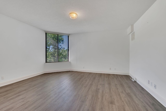 6666 Brookmont Ter Unit 307, Nashville, TN 37205 - empty room featuring wood finished floors, baseboards, and a textured ceiling