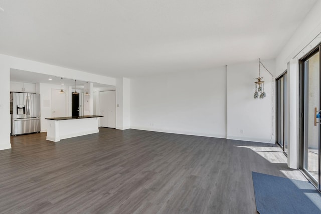 6666 Brookmont Ter Unit 307, Nashville, TN 37205 - unfurnished living room featuring dark wood finished floors, healthy amount of natural light, and baseboards