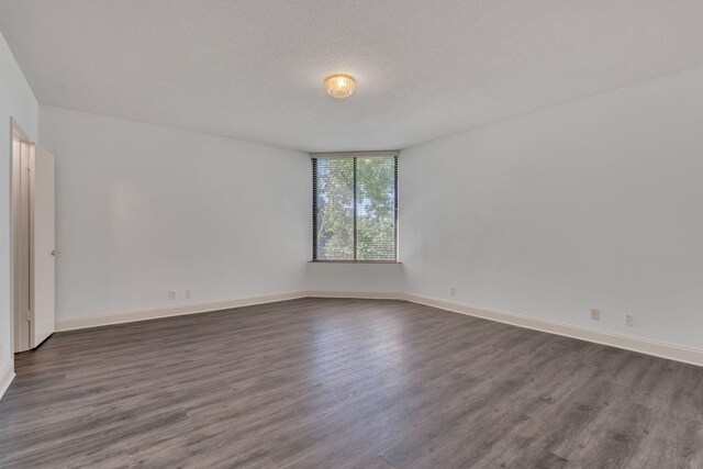 6666 Brookmont Ter Unit 307, Nashville, TN 37205 - empty room featuring dark wood-style floors, baseboards, and a textured ceiling