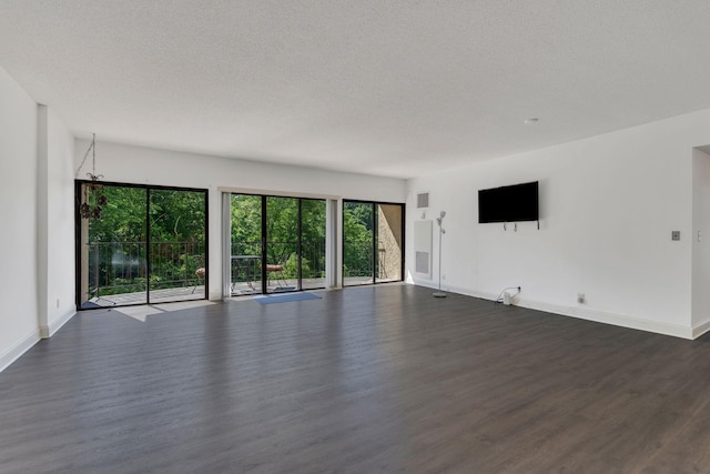 6666 Brookmont Ter Unit 307, Nashville, TN 37205 - unfurnished living room with dark wood-style floors, baseboards, and a textured ceiling