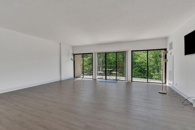 6666 Brookmont Ter Unit 307, Nashville, TN 37205 - spare room with wood finished floors, a textured ceiling, and baseboards
