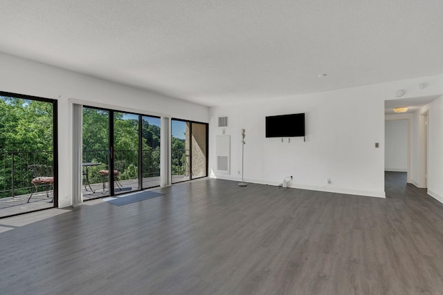 6666 Brookmont Ter Unit 307, Nashville, TN 37205 - unfurnished living room with dark wood-type flooring, baseboards, and a textured ceiling