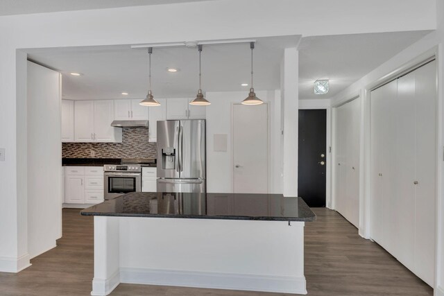 6666 Brookmont Ter Unit 307, Nashville, TN 37205 - kitchen with appliances with stainless steel finishes, under cabinet range hood, white cabinets, dark wood-type flooring, and tasteful backsplash