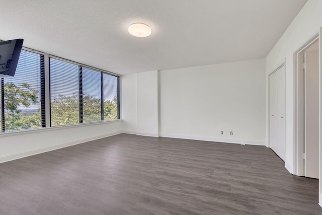 6666 Brookmont Ter Unit 307, Nashville, TN 37205 - spare room featuring plenty of natural light, dark wood finished floors, and baseboards