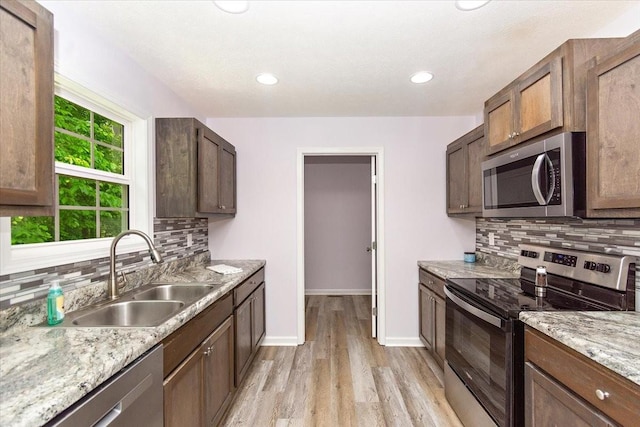1161 Honey Ln, Estill Springs, TN 37330 - kitchen with stainless steel appliances, light wood finished floors, backsplash, and recessed lighting