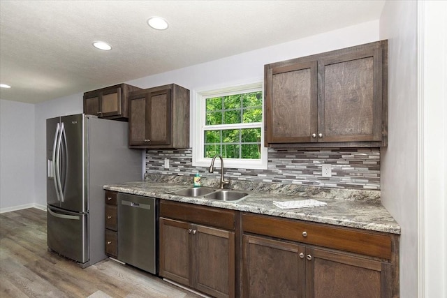 1161 Honey Ln, Estill Springs, TN 37330 - kitchen featuring stainless steel appliances, backsplash, light wood-type flooring, recessed lighting, and dark brown cabinetry