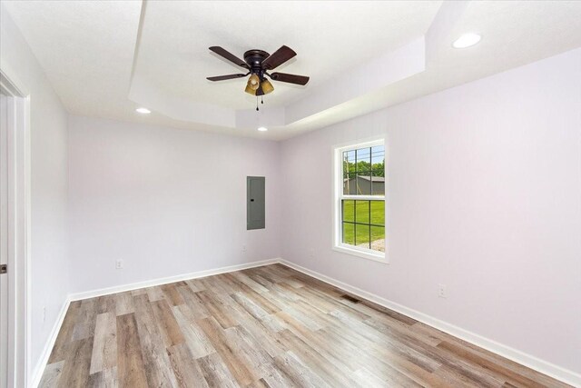 1161 Honey Ln, Estill Springs, TN 37330 - empty room with electric panel, recessed lighting, light wood finished floors, a ceiling fan, and a tray ceiling