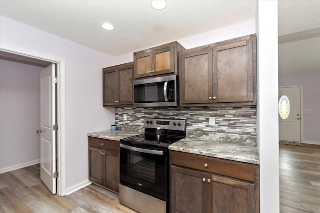 1161 Honey Ln, Estill Springs, TN 37330 - kitchen featuring stainless steel appliances, tasteful backsplash, light wood-type flooring, and recessed lighting