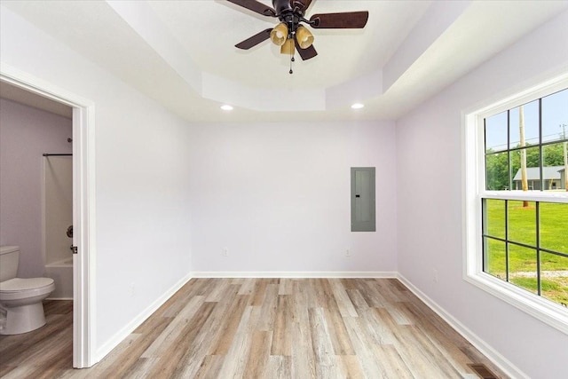 1161 Honey Ln, Estill Springs, TN 37330 - unfurnished room featuring electric panel, light wood-type flooring, a tray ceiling, a ceiling fan, and recessed lighting