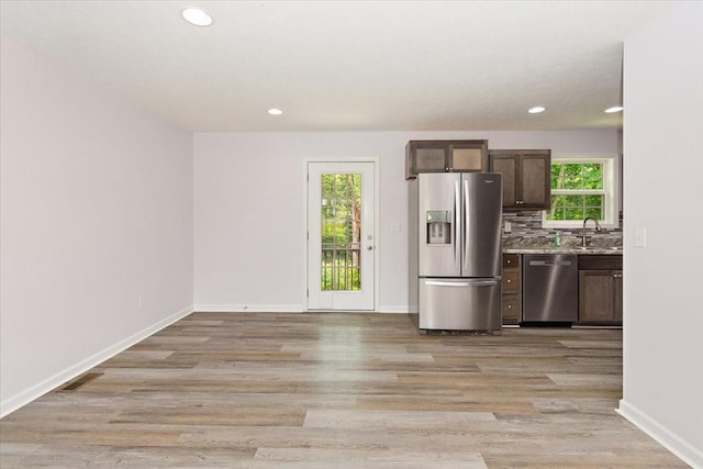 1161 Honey Ln, Estill Springs, TN 37330 - kitchen with appliances with stainless steel finishes, dark brown cabinetry, light wood finished floors, recessed lighting, and backsplash