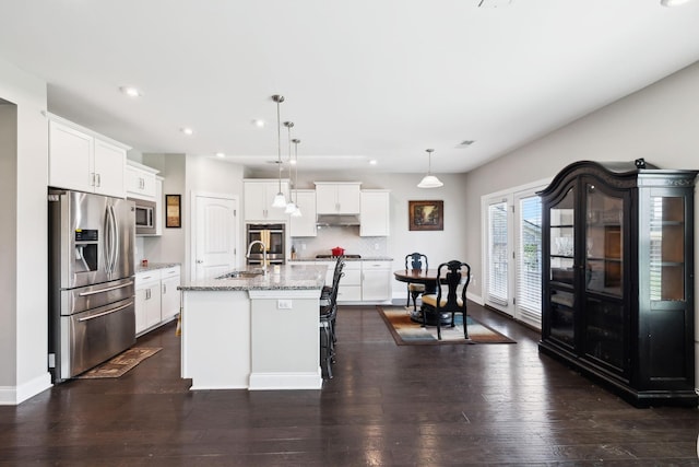 633 Fall Creek Cir, Goodlettsville, TN 37072 - kitchen featuring stainless steel appliances, a sink, under cabinet range hood, recessed lighting, and white cabinetry