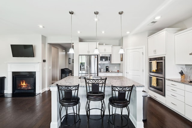 633 Fall Creek Cir, Goodlettsville, TN 37072 - kitchen featuring appliances with stainless steel finishes, dark wood-style flooring, white cabinets, and recessed lighting