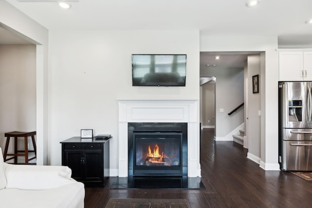 633 Fall Creek Cir, Goodlettsville, TN 37072 - living room featuring dark wood-style floors, stairs, recessed lighting, a glass covered fireplace, and baseboards